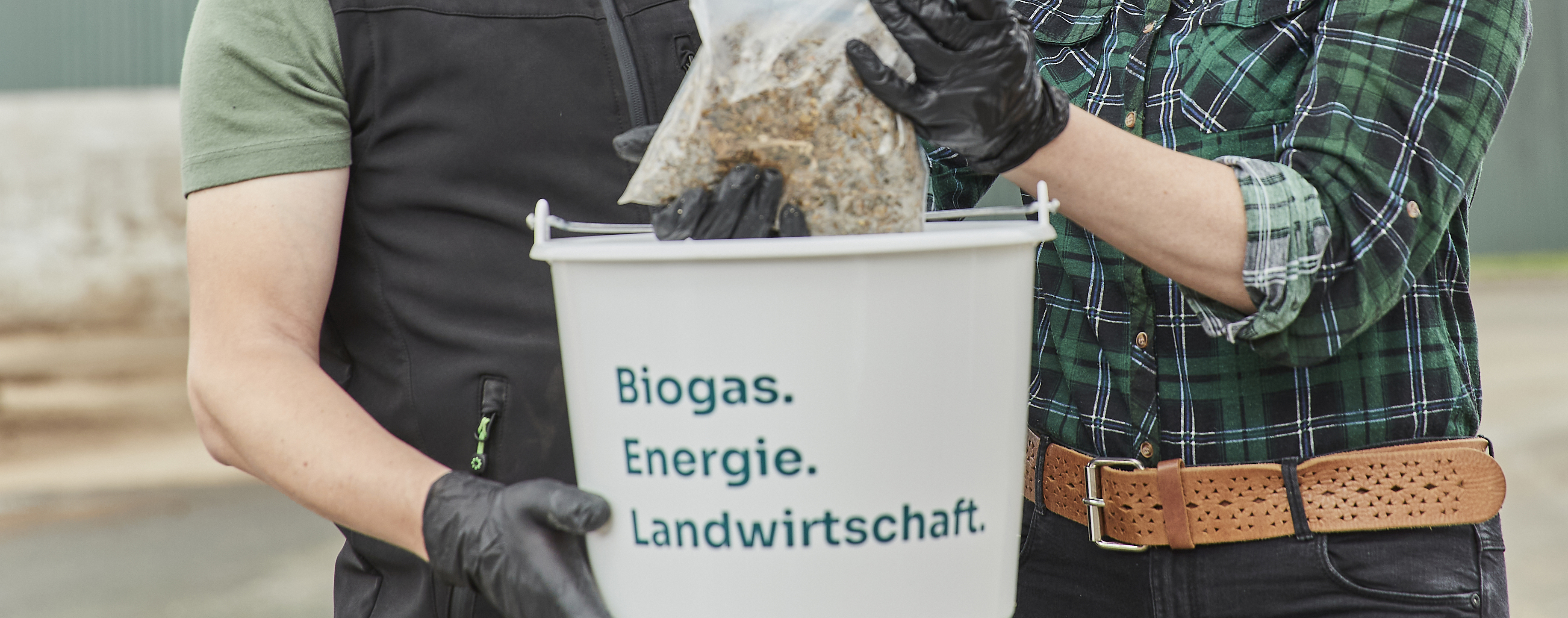 Zwei Personen untersuchen eine Silageprobe.