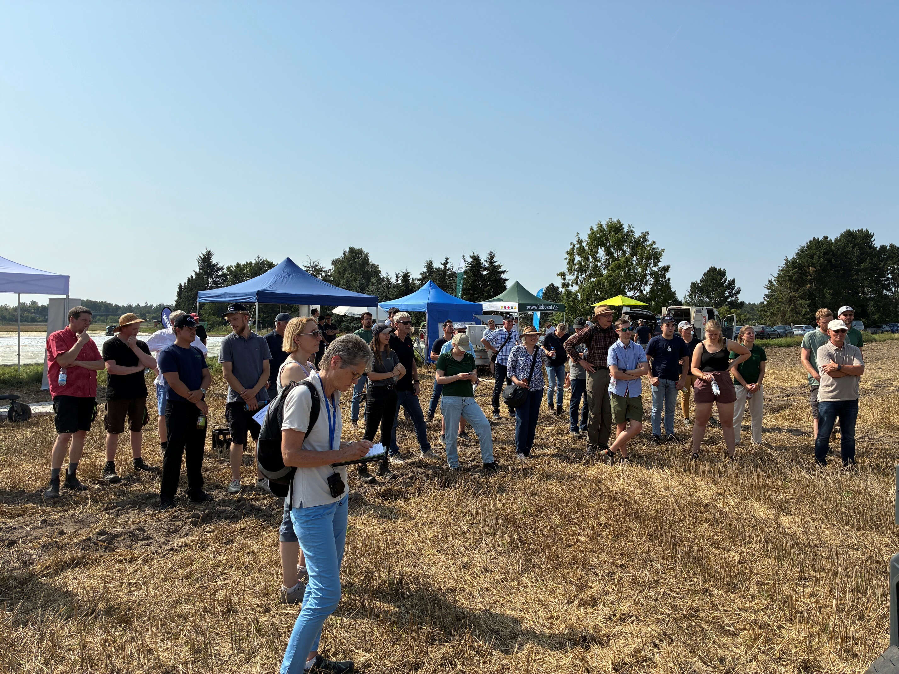 Viele Personen stehen beim Gemüsefeldtag in Otze.